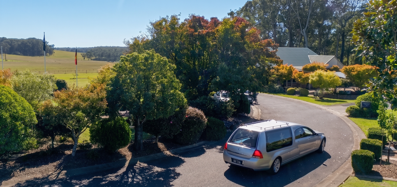 hearse seen from above on a quiet street