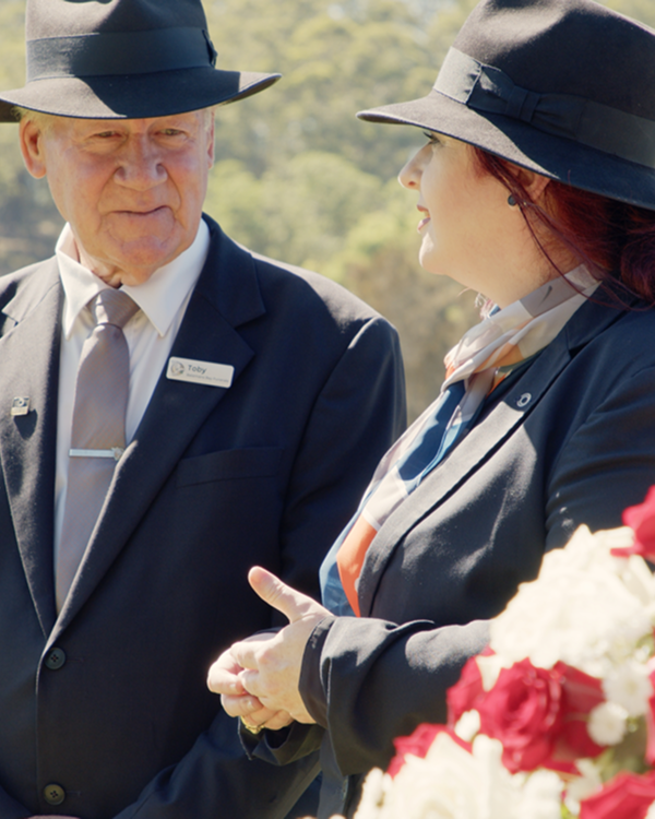funeral arranger in conversation with local man