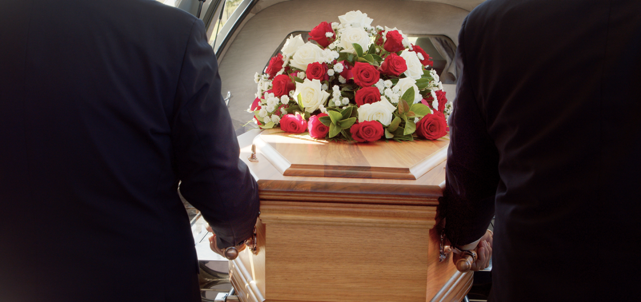 coffin with bouquet of flowers 