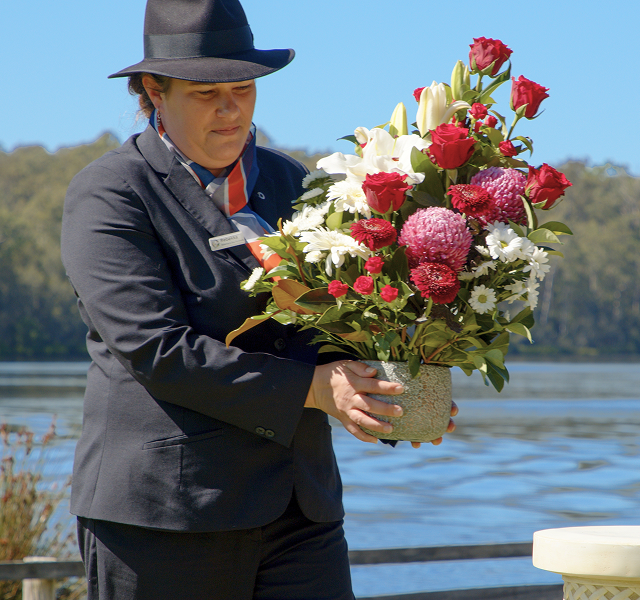 funeral director holding a vase with flowers